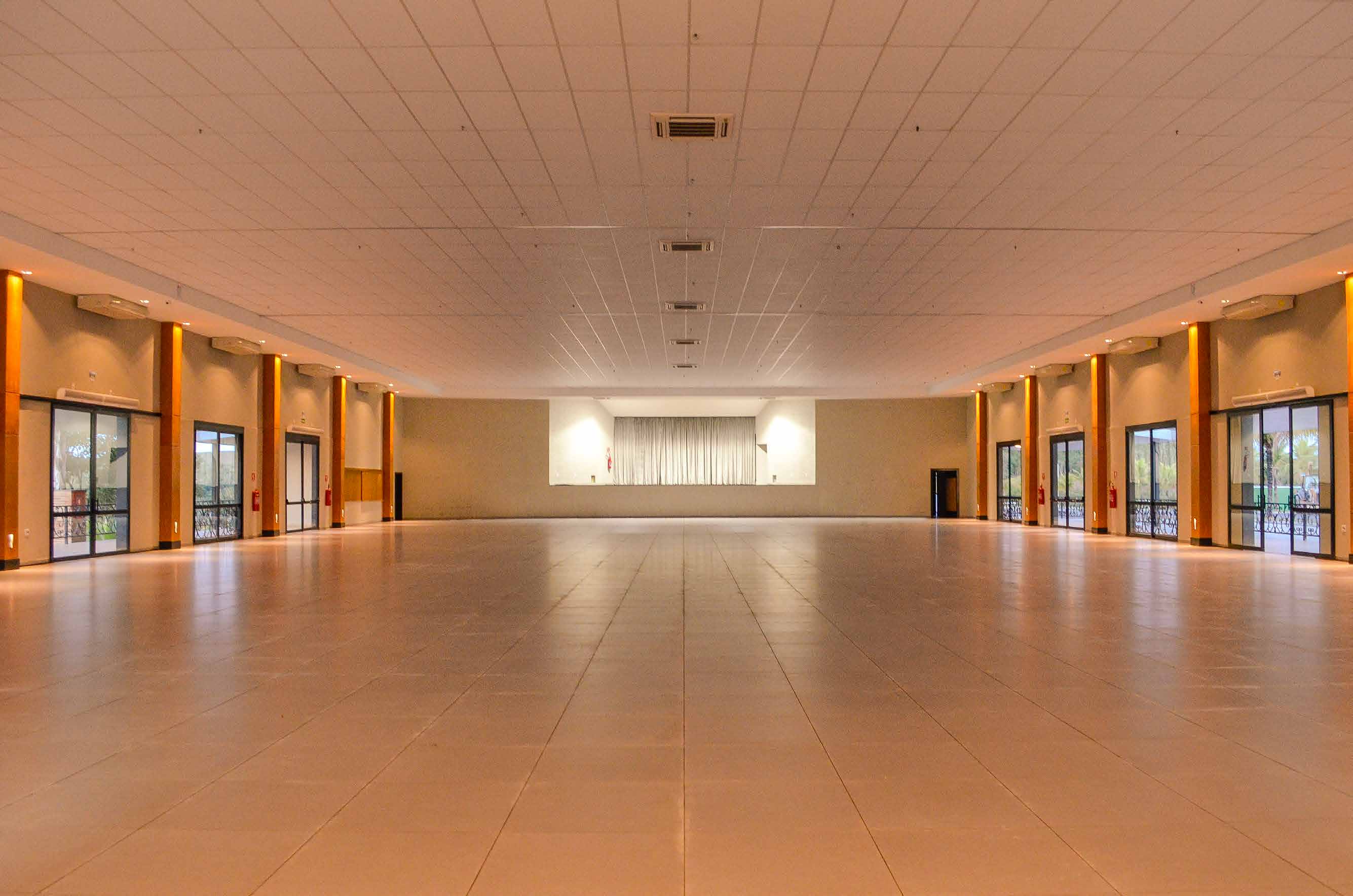 Salão interno do Galpon, amplo e sem colunas, com palco ao fundo